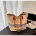 Macro detail of canvas tote bag with TELN embroidery and brown leather handle - Khaki