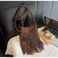 Detail shot of a dark coffee suede crossbody bag with long bohemian fringe accents - Coffee