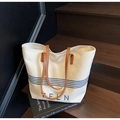 Detail of canvas tote bag with TELN embroidery on wooden steps with art books - Off-white