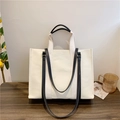 Minimalist off-white canvas tote bag with black straps and large capacity for daily use - Black