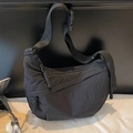 Minimalist black nylon crescent crossbody bag with adjustable strap and waterproof finish - Black