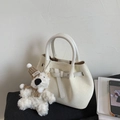 Detail of off-white woven bucket bag with leather buckle and cute plush charm - White (with Pendant)