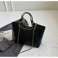 Detailed view of the black quilted tote bag with elegant gold chain shoulder strap - One Size / Black