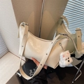 Chic creamy hobo bag with pleated texture, adjustable wide strap and plush puppy charm - Beige With Charm