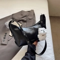 Black ruched leather crescent underarm bag with silver eyelets and plush dog charm - Black With Pendant