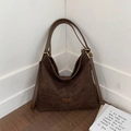 Large dark brown matte leather bucket bag with adjustable strap and fashion tag - Brown