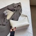 Chic cream white pleated crescent shoulder bag with adjustable strap in a lifestyle setting - Rice White (No Pendant)