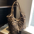 Leopard print tote bag with brown leather handles and a decorative front bow accent - Brown