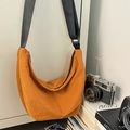Bright orange crescent crossbody bag with adjustable wide strap and nylon texture - Orange