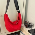 Red nylon crescent crossbody bag with adjustable black strap and minimalist texture - Red