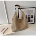 Minimalist khaki suede tote bag with brown leather handles on a decorative table - Off White