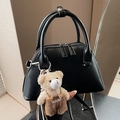 Minimalist black leather bowling handbag with a cute teddy bear charm on the handle - Black with Pendant