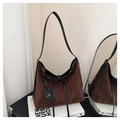 Detail of dark brown faux suede tote bag with black leather trim and brand logo tag - Brown