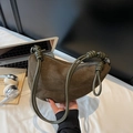 Olive green suede crescent crossbody bag with decorative knotted shoulder strap detail - Green