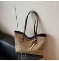 Detail of khaki canvas tote with brown leather straps and colorful beaded tassel charm - Green