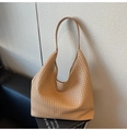 Macro view showing the detailed woven leather texture of the large khaki hobo tote bag - Khaki