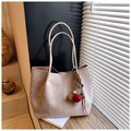 Close-up of large khaki suede tote bag featuring soft texture and decorative pom-pom - Khaki