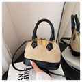 Detail of two-tone shell bag featuring quilted beige suede and black leather accents - Khaki