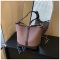 Detail of vintage bucket bag featuring brown suede stitching and adjustable shoulder strap - Brown