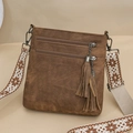 Detailed close-up of brown crossbody bag with multi-zipper pockets and ethnic woven strap - Brown