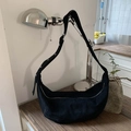 Detail of black matte suede crescent bag showing premium texture and silver metal zipper - Black