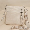 Close-up of beige crossbody bag featuring dual zippers with tassels and jacquard strap - Off White