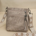 Macro detail of khaki faux leather shoulder bag featuring metallic chain tassel zippers - Khaki