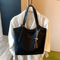 Minimalist black leather tote bag with vintage tassel pendant and thin handles - Black with Pendant