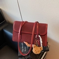 Burgundy faux suede underarm bag with teddy bear charm and braided rope detail - Red