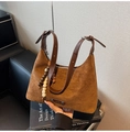 Macro detail of dark brown suede shoulder bag featuring wooden beads and metal logo - Brown with Pendant