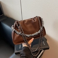 Brown leather pleated cloud shoulder bag with dual silver chain straps on book - Brown