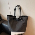 Minimalist black canvas tote bag with leather handles and metallic eyelet details - Black