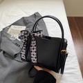 Detail of black leather bucket bag with tricolor silk scarf bow and adjustable strap - Black