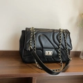 Elegant black quilted crossbody bag with gold chain strap and wave stitching design - Black