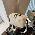 Minimalistische beige Nylon-Umhängetasche mit Reißverschlüssen und breitem Gurt in Ansicht - Cremeweiß