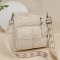 Detail of beige crossbody bag with double zippers, tassel charm and ethnic strap - Off White