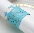 Close-up of laser-cut sky blue paper napkin ring with reindeer and snowflake details - Tiffany Blue