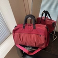 Large red travel bag with white grid pattern and comfortable shoulder straps - Burgundy