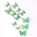 Dettaglio di 12 farfalle 3D verdi traforate con motivi di stelle e fiori intagliati - Confezione (12 Unità) / Verde scuro specchio