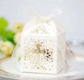 Laser cut white cross wedding favor box with floral patterns and a chiffon ribbon tie - Ivory