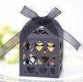 Detail showing laser-cut heart patterns on black gift box with an organza ribbon bow - Black