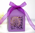 Detail of laser-cut purple hollow wedding favor box with a rose floral pattern and ribbon - Dark Purple