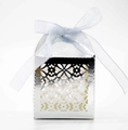 Detail of silver laser-cut hollow candy box with floral patterns and blue silk ribbon bow - Reflective Silver