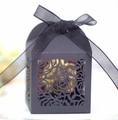 Detail of hollow laser-cut rose patterns on black wedding favor box with ribbon - Black
