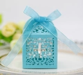 Macro detail of laser-cut light blue favor box with cross pattern and blue ribbon bow - Tiffany Blue