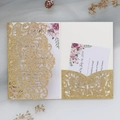Detail of laser-cut gold glitter wedding invitation with elegant floral cards and envelope - Gold