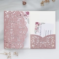 Close-up of pink glitter laser-cut wedding invitation with elegant floral insert card - Pink