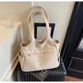 Detail of a large beige canvas tote bag with front zipper and side pockets on a suitcase - Beige Grey