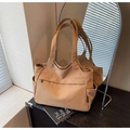 Detail view of khaki canvas tote bag with front zipper pocket and side pockets for storage - Brown