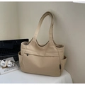 Detail of a khaki canvas tote bag with side pockets and a front zipper pocket for travel - Khaki